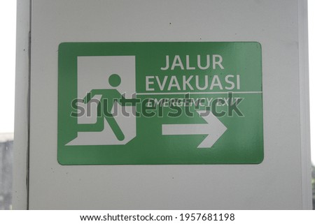 Evacuation route signs on walls.