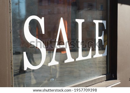 Black Friday concept. Large white text SALE on the shop window, outside