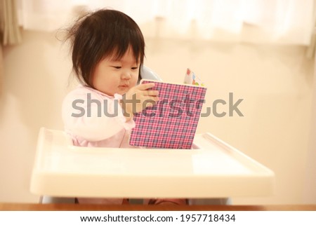 Baby reading a picture book 
