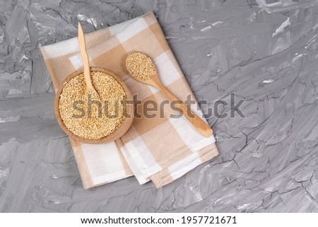 dry quinoa cereal bowls on grey concrete background table. Gluten free cereals