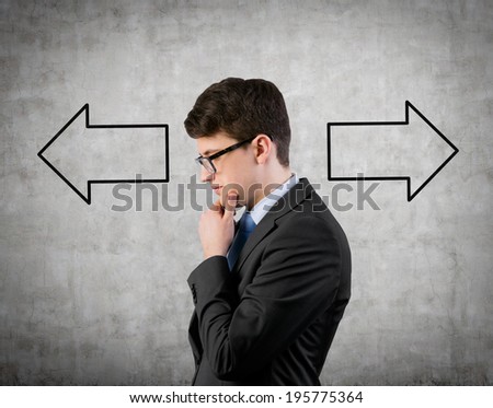 Businessman and arrows 'left or right' 