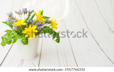 Bright and juicy wildflowers on a wooden background