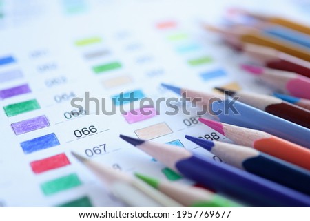 Colored pencils are on color palette with numbers