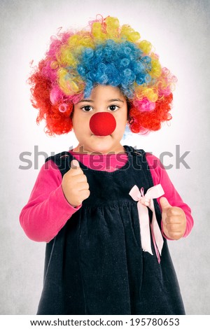 Little child with clown mask holding thumb up