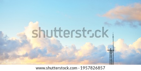 Clear blue sky with glowing pink and golden cumulus clouds after storm at sunset. Dramatic cloudscape. Concept art, meteorology, heaven, hope, peace, graphic resources, picturesque panoramic scenery Royalty-Free Stock Photo #1957826857