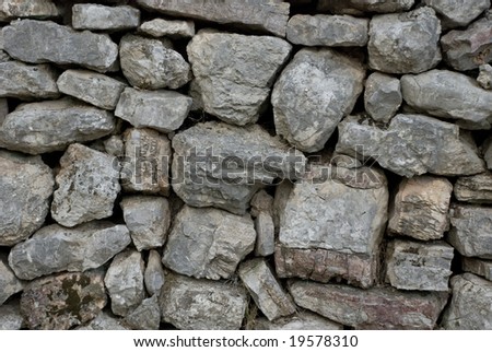 Old wall built by the grey stone