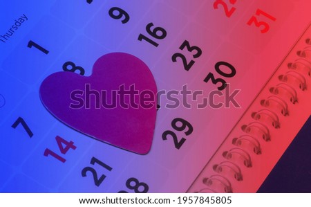 Valentine's day concept. Calendar with February 14 date and heart. Neon light