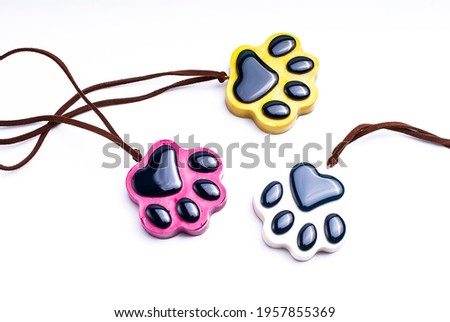 Dog footprints, pendants. On white background