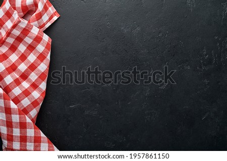 Red tablecloth on kitchen table black color with for your recipe or menu. Top view flat lay. Mock up.