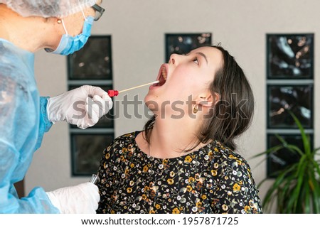 doctor takes a swab from the girl's mouth, DNA test, PCR test