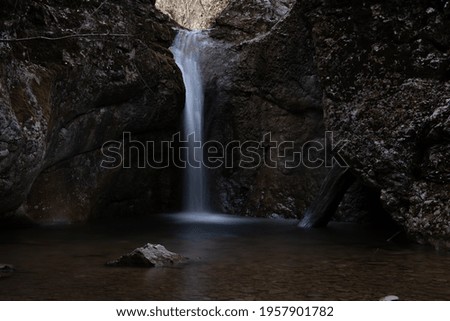 mountain river with foliage and waterfalls