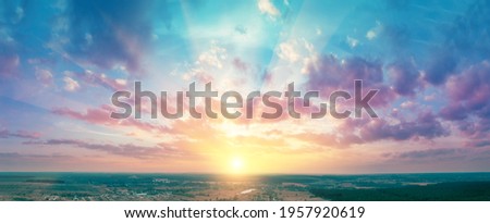 Panorama of the countryside with beautiful colorful evening sky during sunset. View from above