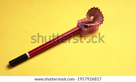 Pencil isolated on yellow background.