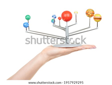 Hand with model of solar system isolated on white