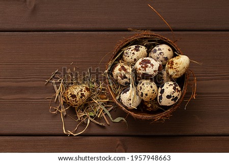 Fresh quail eggs, in a plate of coconut, on a wooden brown table, top view, horizontal, no people,
