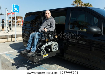 Disabled man on wheelchair car lift