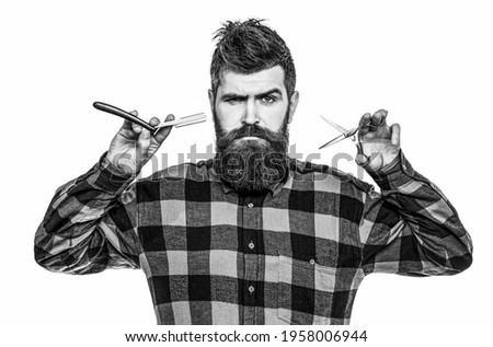 Barber scissors and straight razor, barber shop. Mens haircut, shaving. Bearded man, long beard, brutal, caucasian hipster with moustache. Mens haircut in barber shop. Black and white.