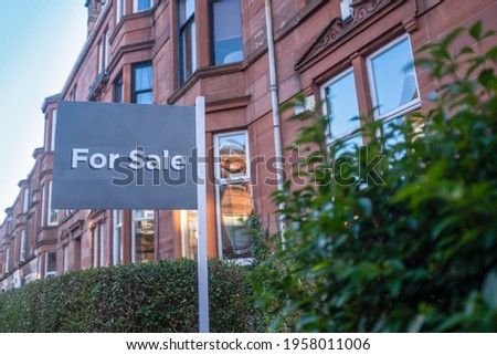 A For Sale Sign Outside A Traditional Red Sandstone Tenement Flat (Apartment) In Glasgow