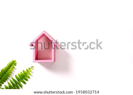 Pink model house on white background.Mortgage property insurance dream home concept. Flat lay top view copy space banner.