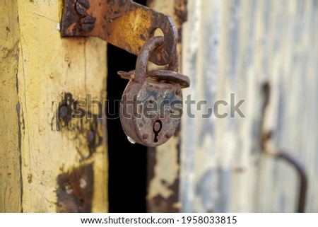 Old padlock with rust but fully functional photographed in the studio                           