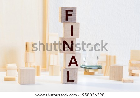 Final word written on wood cube with red background.
