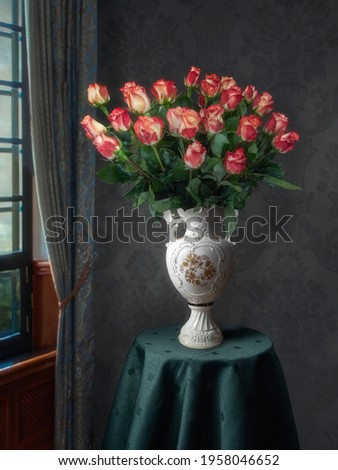 Still life with luxurious bouquet of roses in old vase