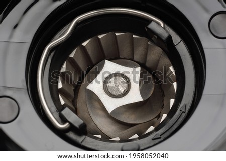 Coffee burr mill grinder conical blades spare part. Cleaning or service concept Royalty-Free Stock Photo #1958052040