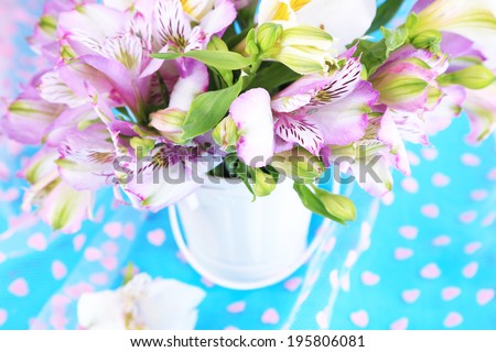 Bouquet of freesias in pail on table close-up