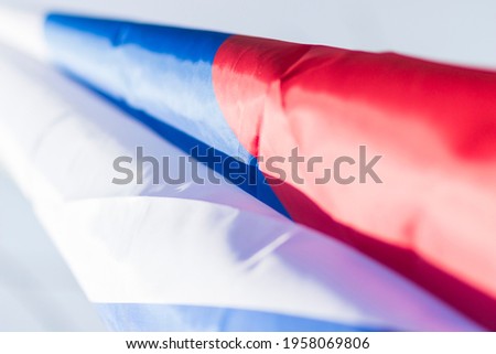 Children's hand of a small child and the Russian tricolor