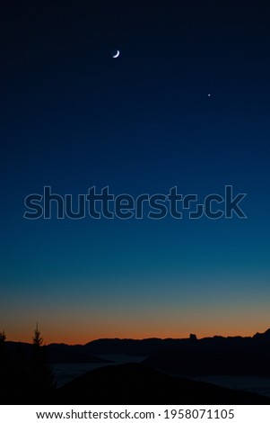 Nightfall on the mountainous horizon one winter evening Royalty-Free Stock Photo #1958071105