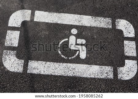International Symbol of Access Wheelchair Symbol Handicap Sign on asphalt parking permit close up view