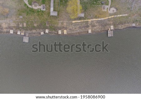 Fishing piers made of wood on the lake. View from above