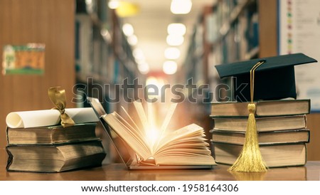 Online education, school study course, e-learning class, e-book digital technology and global educational success graduation concept with mortarboard and open computer notebook in library classroom  Royalty-Free Stock Photo #1958164306