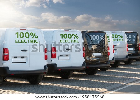 Electric vans parked in a row Royalty-Free Stock Photo #1958175568