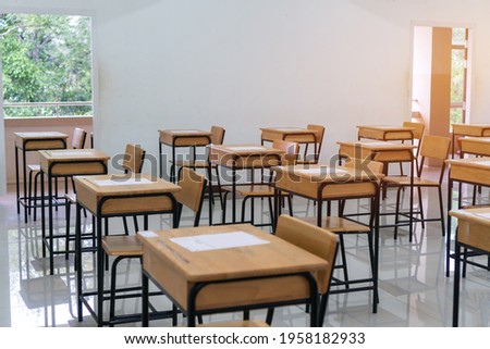 School empty classroom with test sheet or exams paper on desks chair wood at high school thailand, Empty classroom no childrens when COVID-19 disease outbreak and closed quarantine