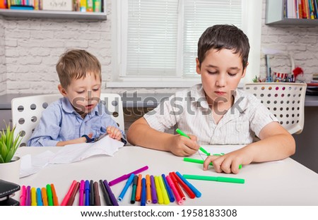 Cute boys studying drawing at school. Happy family drawing pictures. Kids draw in creativity at home together. Children are painting in kindergarten. Preschooler little boy drawing in nursery room