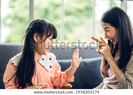 Portrait of enjoy happy love asian family mother and little asian girl child smiling and having fun play with cute kid daughter moments good time at home