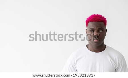 Black lives matter. Serious man. Social tolerance. Advertising background. Attractive stylish african guy with bright pink hair white t-shirt isolated light copy space.