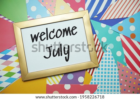 Welcome July text on colorful background