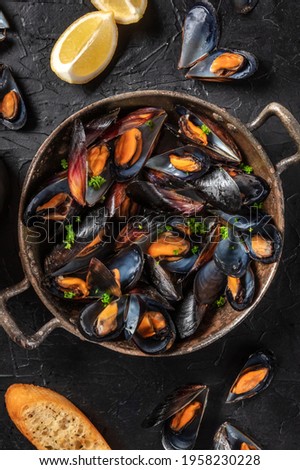 Mussels in a pan, shot from the top with lemon and toasted bread Royalty-Free Stock Photo #1958230228