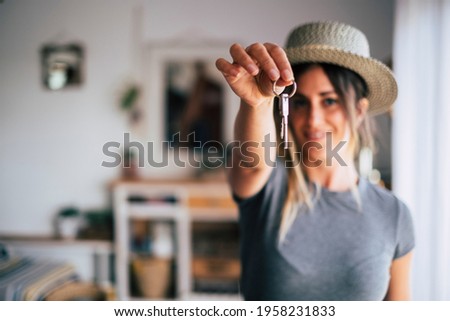 Crop close up of female tenant renter show praise house keys moving to first own new apartment or house, happy woman owner buy purchase home, relocate to dwelling, rental, rent, ownership concept Royalty-Free Stock Photo #1958231833