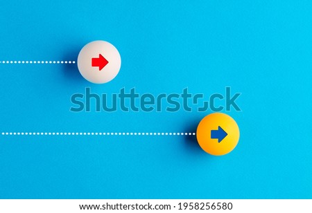 Table tennis balls are racing with each other on blue background. Internet speed, competition, race or challenge concept.