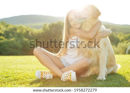 Teenager girl with a dog in nature. High quality photo.