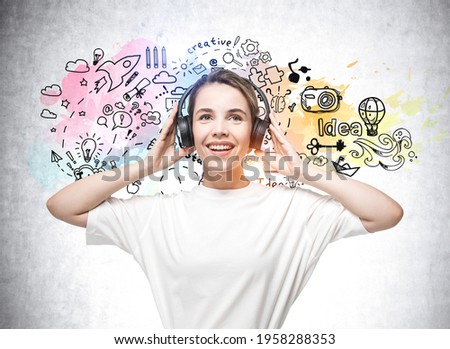Student woman in t-shirt with wireless headphones, listening to music, podcast. Colourful social communication icons on concrete background. Concept of network, technology and interface
