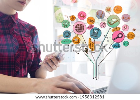 Woman using smartphone in office interior with laptop, network bright icons drawing. Social media, worldwide connection and web communication. Concept of secretary