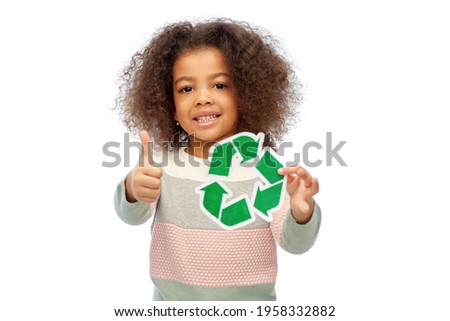 eco living, environment and sustainability concept - smiling african american girl holding green recycling sign showing thumbs up over white background