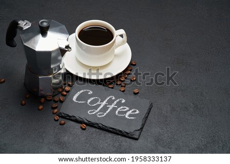 Coffee handwritten inscription sign on chalk board and cup of espresso coffee