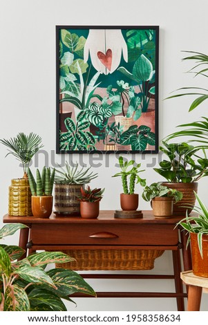 Domestic interior of living room with vintage retro shelf, a lot of house plants, cacti, wooden mock up poster frame on the white wall and elegant accessories at stylish home garden. Template. 