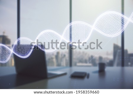 Double exposure of creative DNA hologram and modern desktop with laptop on background. Bio Engineering and DNA Research concept