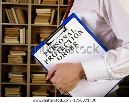 Man with clipboard and papers about Personal protection order PPO. Royalty-Free Stock Photo #1958371930